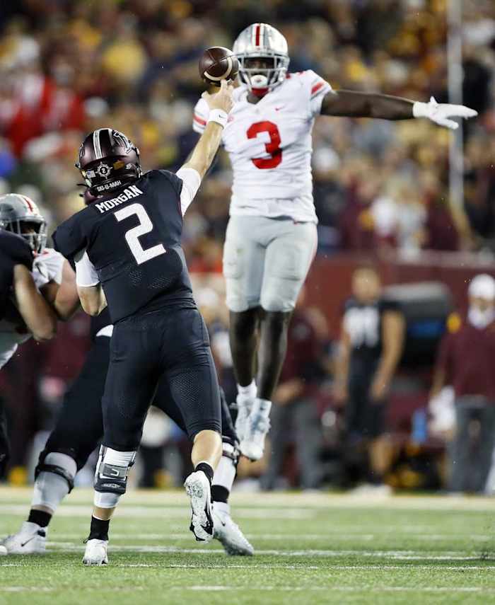 Linebacker Teradja Mitchell (3) tries to block the throw of Minnesota Golden Gophers quarterback Tanner Morgan (2). 